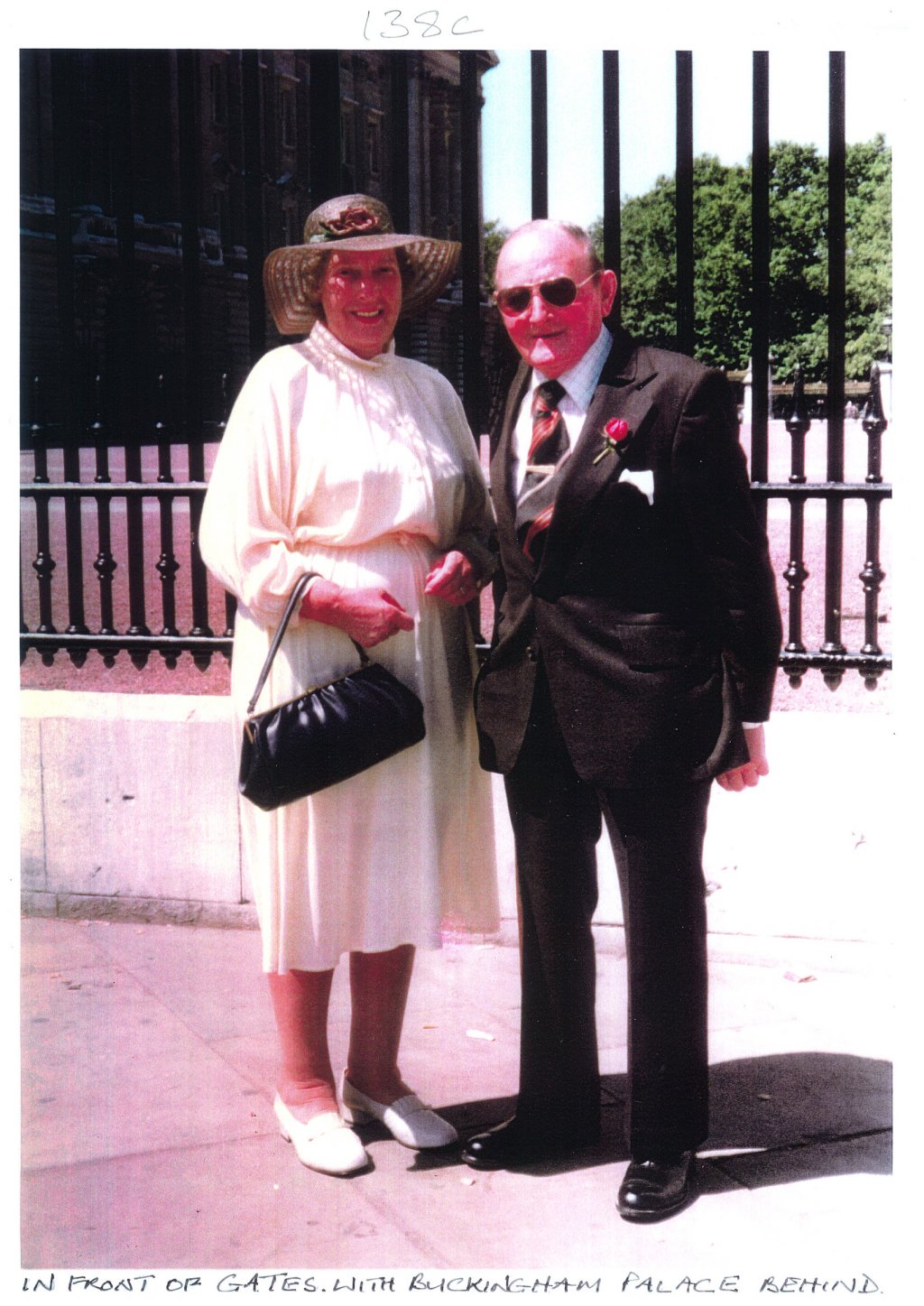 In front of the gates with Buckingham palace behind